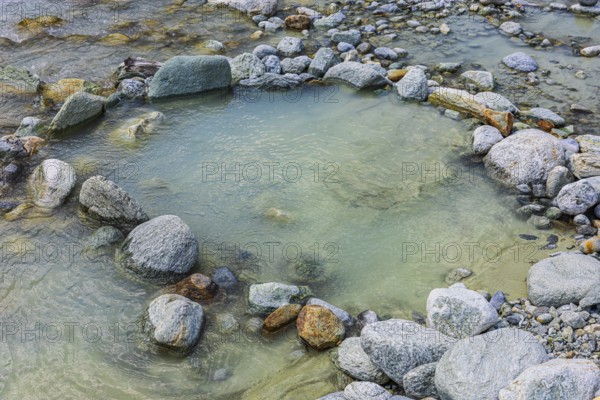 Boulders form a circle in the mountain stream La Navisence, near Zinal, Val d'Anniviers, Valais Alps, Canton Valais, Switzerland