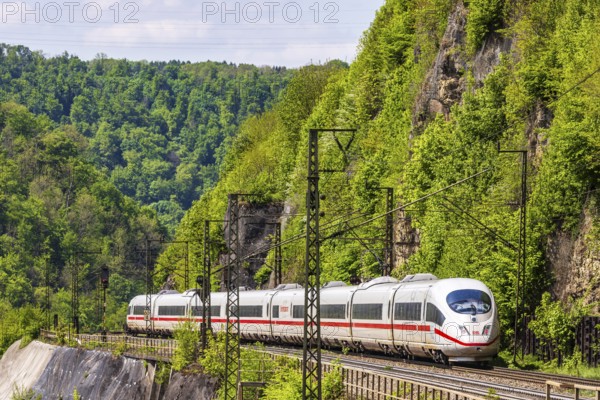 InterCityExpress ICE en route on the winding railway line of the Geislinger Steige. Landscape on the railway's Filstalline line in spring. Amstetten, Baden-Württemberg, Germany