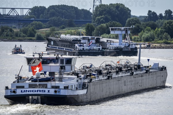 Cargo ships on the Rhine, in the background the Rhine bridge near Duisburg-Rheinhausen, Bridge of Solidarity, Duisburg, North Rhine-Westphalia, Germany