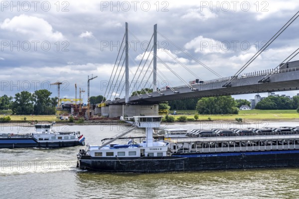 Rhine bridge Duisburg-Neuenkamp, the A40 motorway, start of construction of the second bridge, bridge piers and the first bridge segment are erected on the Neuenkamp side of the Rhine, cargo ship on the Rhine, North Rhine-Westphalia, Germany