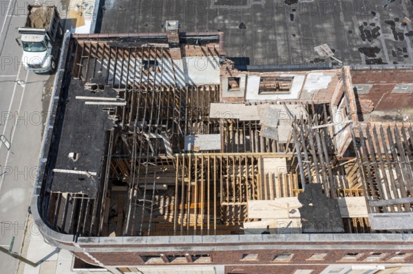 Detroit, Michigan - Workers rehab a long-vacant and crumbling commercial building in the Morningside neighborhood. The project, called Ultreia, will contain first floor commercial space and apartments above