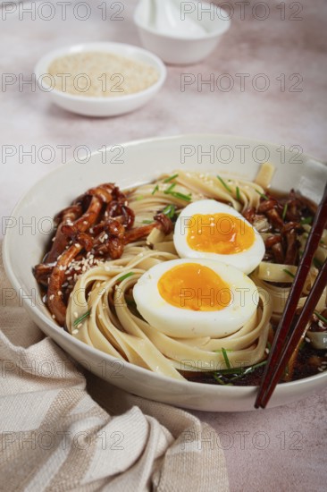 Buckwheat noodles soba with shimeji mushrooms, with boiled egg, green onion, sesame seeds, homemade, without people