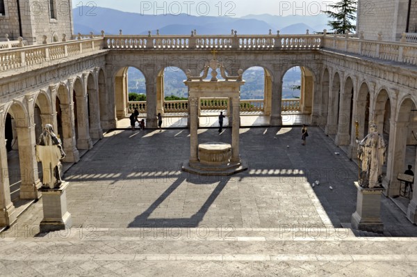 Bramante cloister with cistern and statues of St Benedict and St Scholastica of Nursia, Benedictine Abbey of Montecassino, Monte Cassino, Cassino, Frosinone, Lazio, Italy