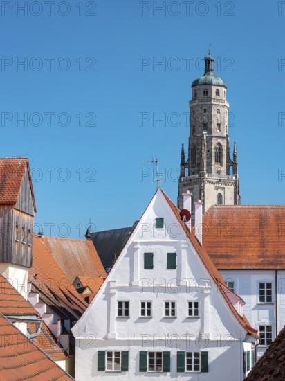 View from the medieval town wall over the houses of the historic old town to the tower of St George's Church, called Daniel, Nördlingen, Bavaria, Germany