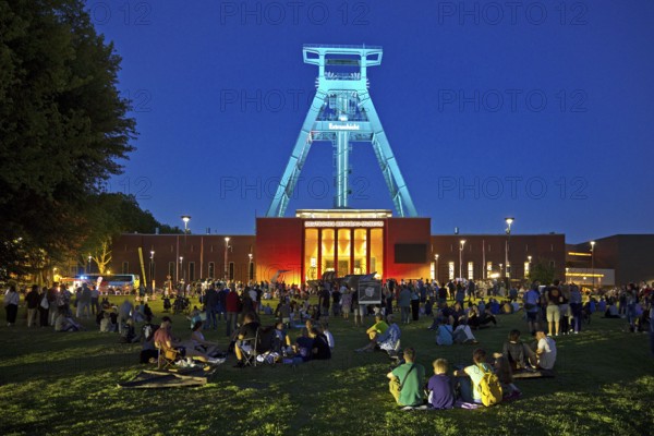 People in front of the German Mining Museum for the Extra Shift at night, Bochum, Ruhr Area, North Rhine-Westphalia, Germany