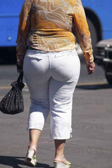 Woman walking in the street, From behind, Obesity, City of Quito. Pichincha province, Ecuador, South America