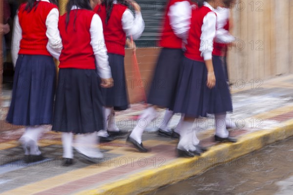 Group of female students walking to the college, Motion blur, City of Otavalo, Imbabura province, Ecuador, South America