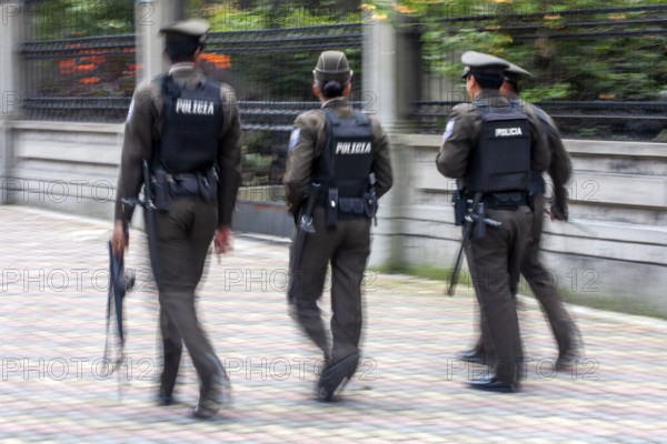 Policemen walking in the street, Motion blur, City of Quito. Pichincha province, Ecuador, South America
