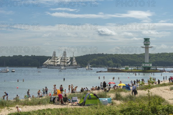 Windjammer parade 2025 on the Kiel Fjord at the end of Kiel Week, tall ships, three-master, sail training ship Gorch Fock, spectators, Falkenstein beach life, lighthouse, summer weather, sunshine, forest, Kiel, Schleswig-Holstein, Germany