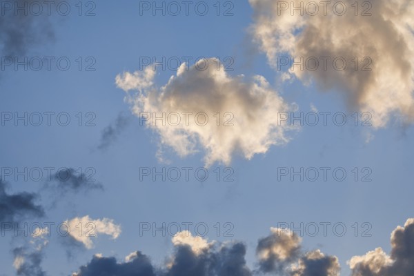Black and white clouds in the blue evening sky