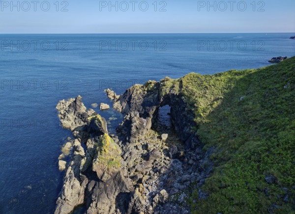 Rocky coast and rock gate on the south-east coast near the southern tip of Cornwall on the English Channel. Cadgwith, Cornwall, South West England, Great Britain