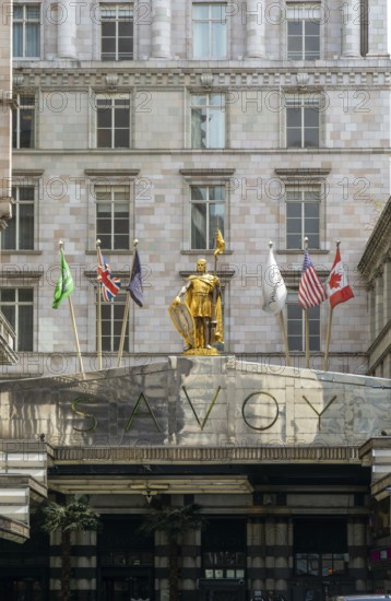 Count Peter of Savoy golden figure above entrance to The Savoy hotel, Strand, central London, England, UK