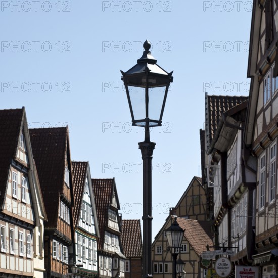 Street with half-timbered houses and historic street lamp in the old town centre, Celle, Lower Saxony, Germany