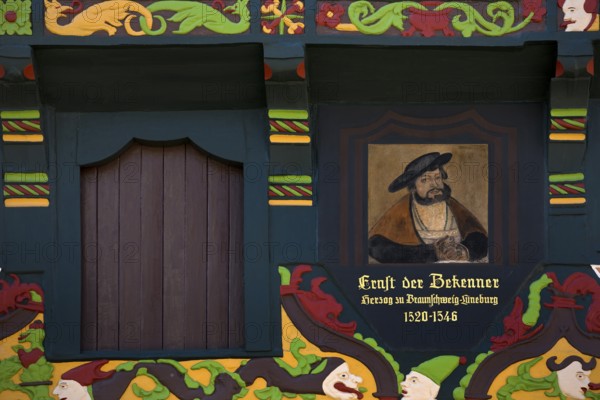 Hoppenerhaus, the most magnificent half-timbered house in the historic centre of Celle with a picture of Duke Ernst the Confessor, detail with painted wood carvings, Celle, Lower Saxony, Germany