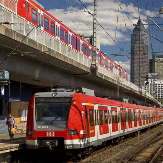 Two regional express trains on different levels at Frankfurt West station with Messeturm, Frankfurt am Main, Hesse, Germany
