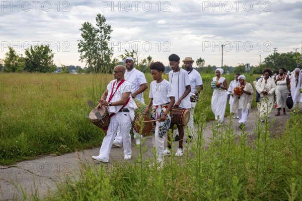 Detroit, Michigan - African-Americans gather on the banks of the Detroit River to commemorate ancestors lost in the slave trade. The annual event, known as The Carnival of the Spirit, is organized by the African Diaspora Ancestral Commemoration Institute