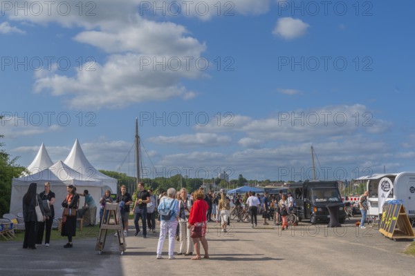 Waterkant Festival 25 in front of Kiel Week 2025 on the MGF 5 site on the Kiel Fjord, annual meeting place for founders of start-up companies with innovative ideas for new technologies, ecology and society, workshops and exhibitions, discussions in the outdoor area at Kiel Holtenau, Schleswig-Holstein, Germany