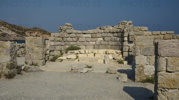 Remains of an ancient stone structure under a clear blue sky, Agios Stefanos Beach, Agios Stefanos Basilica, Agios Nikolaos Chapel, Kastri Island, Kos, Dodecanese, Greek Islands, Greece