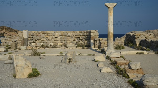Ancient site with a single stone column and ruins, near the sea, Agios Stefanos Beach, Agios Stefanos Basilica, Agios Nikolaos Chapel, Kastri Island, Kos, Dodecanese, Greek Islands, Greece