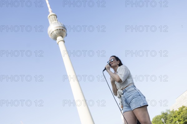 Singer Veronika Bognar on Alexanderplatz as part of the Fête de la Musique. The music event, which originated in France, has been held as a street event on the longest day of the year on 21 June since 1982. The Fête de la Musique has also been held in Berlin since 1995 and is celebrating its 30th anniversary this year. 21.06.2025