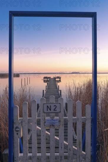 View along a footbridge through a door frame to the Steinhuder Meer in the evening light, Great White Egret (Ardea alba, Syn.: Casmerodius albus, Egretta alba), Landscape photo, Nature photo, Mardorf, Neustadt am Rübenberge, Hanover Region, Lower Saxony, Germany