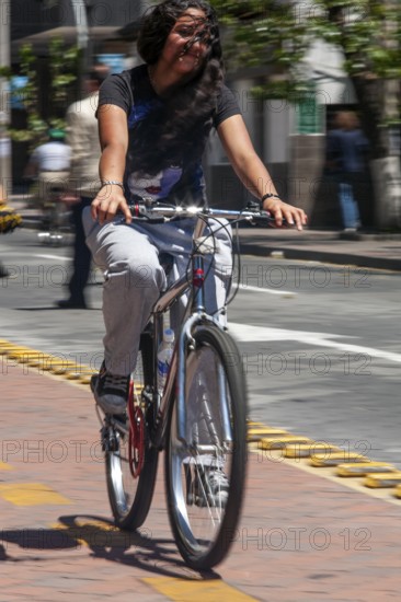 Woman riding a bicycle, Photo with motion blur, City of Quito, Pichincha province, Ecuador, South America