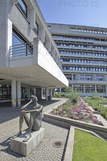 Sculpture Listening man by Fritz Nuss 1963, modern art, bronze sculpture, male figure, listening, hearing, gesture, hand on ear, arm, sitting, naked, Square of 23 February 1945, New Town Hall, Pforzheim, Northern Black Forest, Black Forest, Baden-Württemberg, Germany