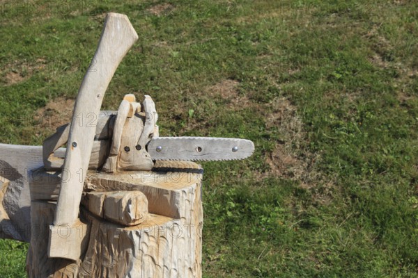Chainsaw and axe carved from wood as decoration