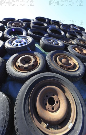 Old wheels, rims and tyres, used here to weigh down the cover of an agricultural silo