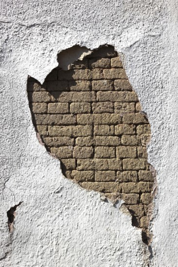 Building damage, wall damage, flaking plaster and wall paint, bricks