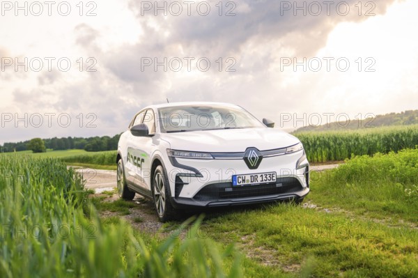 A white Renault vehicle parked on a dirt track under a cloudy sky, Deer E- CarSharing, Renault Megane electric car, Calw, Black Forest, Germany