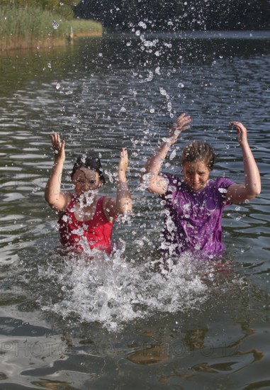 Girls splashing in the lake, Allgäu, Bavaria, Germany, Allgäu, Bavaria, Germany