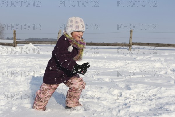 Girl running through the snow, Allgäu, Bavaria, Germany, Allgäu, Bavaria, Germany