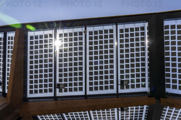Transparent solar roof of the electric charging station on the site of the former Lohberg colliery in Dinslaken, operated by Fastned, uses electricity from wind and solar power, fast-charging stations, North Rhine-Westphalia, Germany