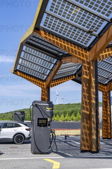 Electric charging station on the site of the former Lohberg colliery in Dinslaken, operated by Fastned, uses electricity from wind power and solar energy, fast-charging columns, with its own solar roof, wind farm on the Lohberg slagheap, North Rhine-Westphalia, Germany