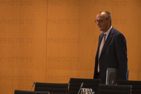 Federal Chancellor Friedrich Merz (l, CDU) arrives for the consultation between Federal Chancellor Friedrich Merz and the heads of government of the federal states in the International Conference Hall of the Federal Chancellery, Berlin, 18 June 2025