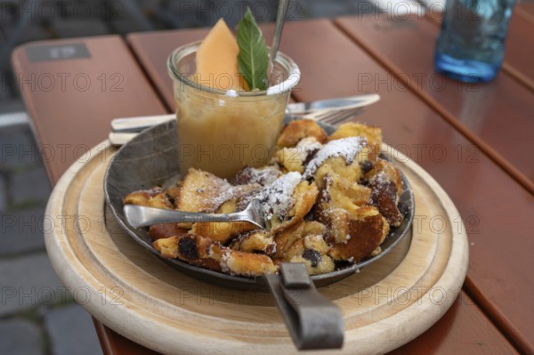 Kaiserschmarrn with apple sauce served in a small pan, Franconia, Bavaria, Germany