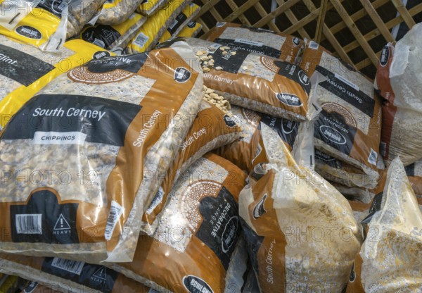 South Cerney stone chippings bags stacked up at Lowden garden centre, Wiltshire, England, UK