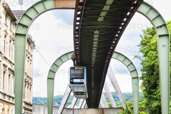 The Wuppertal suspension railway runs through Vohwinkel in front of buildings from the Wilhelminian era near the Hammerstein stop in Wuppertal, Germany