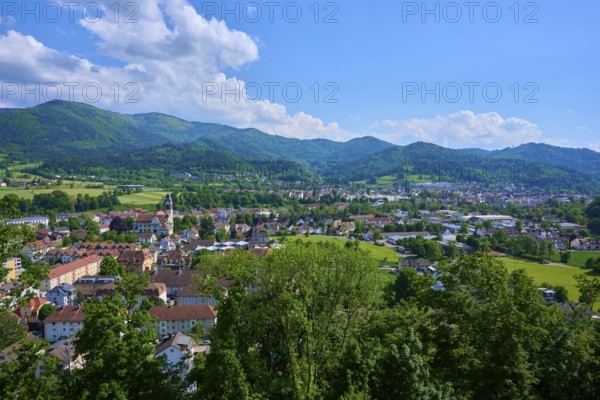 View of a district town surrounded by green hills under a cloudy blue sky, Waldkirch, Breisgau, Black Forest, Baden-Württemberg, Germany