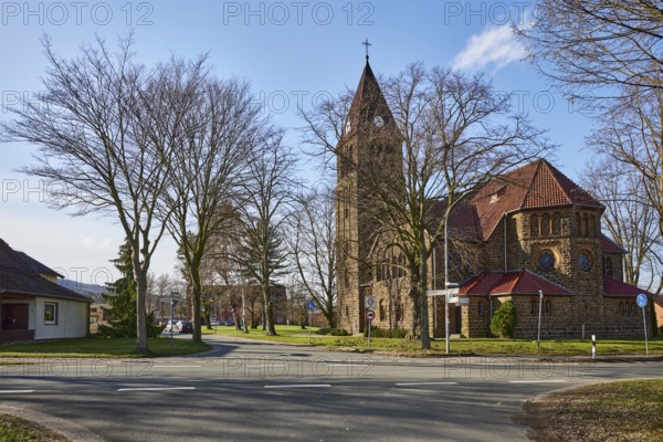 Church Oberlübbe, Evangelical-Lutheran parish Oberlübbe-Rothenuffeln, residential building, bare winter trees, blue sky with cumulus clouds, intersection Ellernstraße with Korfskamp, Hille, Mühlenkreis Minden-Lübbecke, North Rhine-Westphalia, Germany