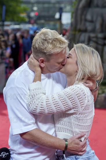 Jens Knossi Knossalla with girlfriend Lia Mitrou (influencer) at the German premiere of the adventure film Jurassic World: Rebirth at Berlin's Zoo Palast on 18 June 2025