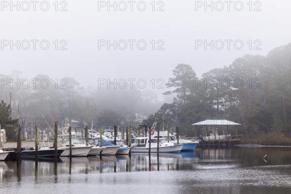 Private fishing boats in the harbor at Ocean Springs, Mississippi on a foggy morning