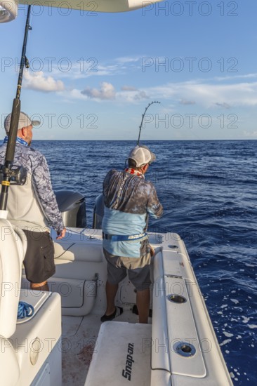Offshore fisherman reeling in a fish in the Gulf of Mexico