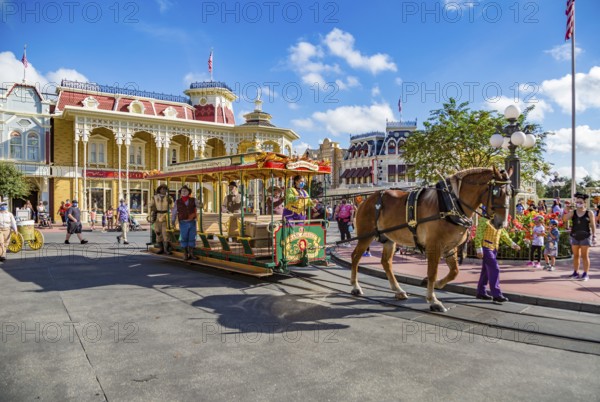 Horse pulling trolley car with Disney characters down Main Street in the Magic Kingdom at Walt Disney World, Orlando, Florida