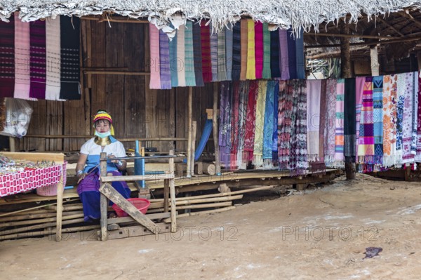 Tribal woman selling woven scarves and other crafts in the Long Neck Karen tribe (more properly called the Kayah Lahwi tribe) area of the Union of Hill Tribe Villages outside of Chiang Rai in the Nanglae District of Thailand