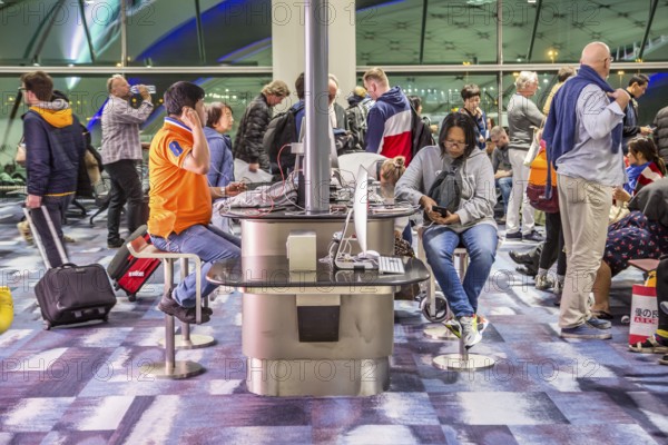 Travellers using Internet station at gate in terminal of Suvarnabhumi Airport at Bangkok, Thailand