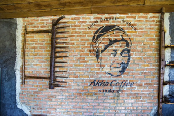 Logo painted on brick wall at the Akha Cottage restaurant and coffee shop in Chiang Rai, Thailand