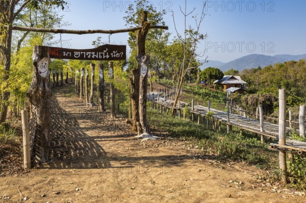 Walkway at the Akha Cottage coffee shop and restaurant in Chiang Rai Thiland asks What is your mood today? and has painted faces with differerent expressions of moods