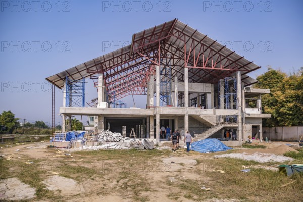 American men entering jobsite while volunteering to help build the Grace Language School and Baan Athitaan Church building in Chiang Rai, Thailand
